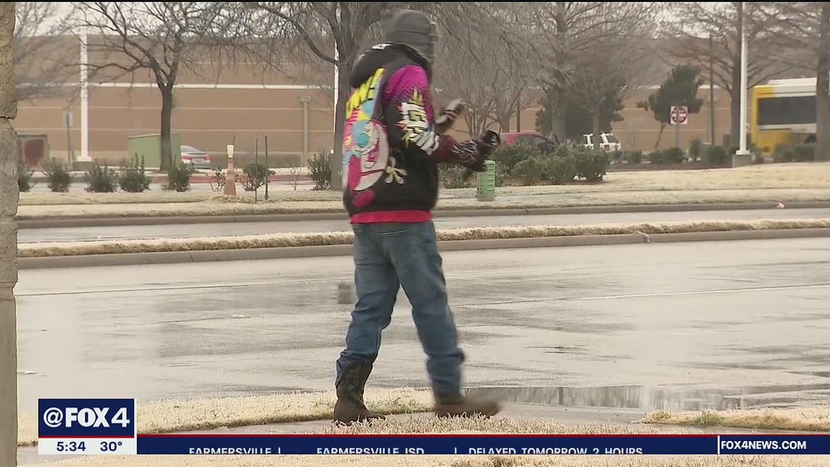 While most stay home, some Dallas pedestrians venture out in icy weather